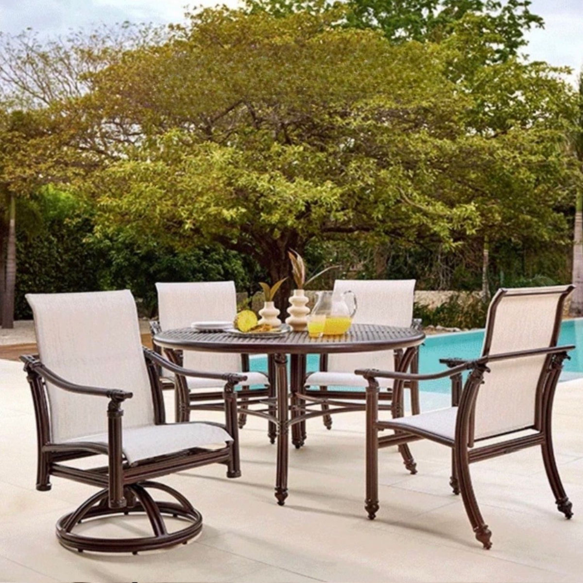 Coco, Castelle 54" Round Outdoor Dining Table, aluminum rattan-inspired detailing across tabletop 