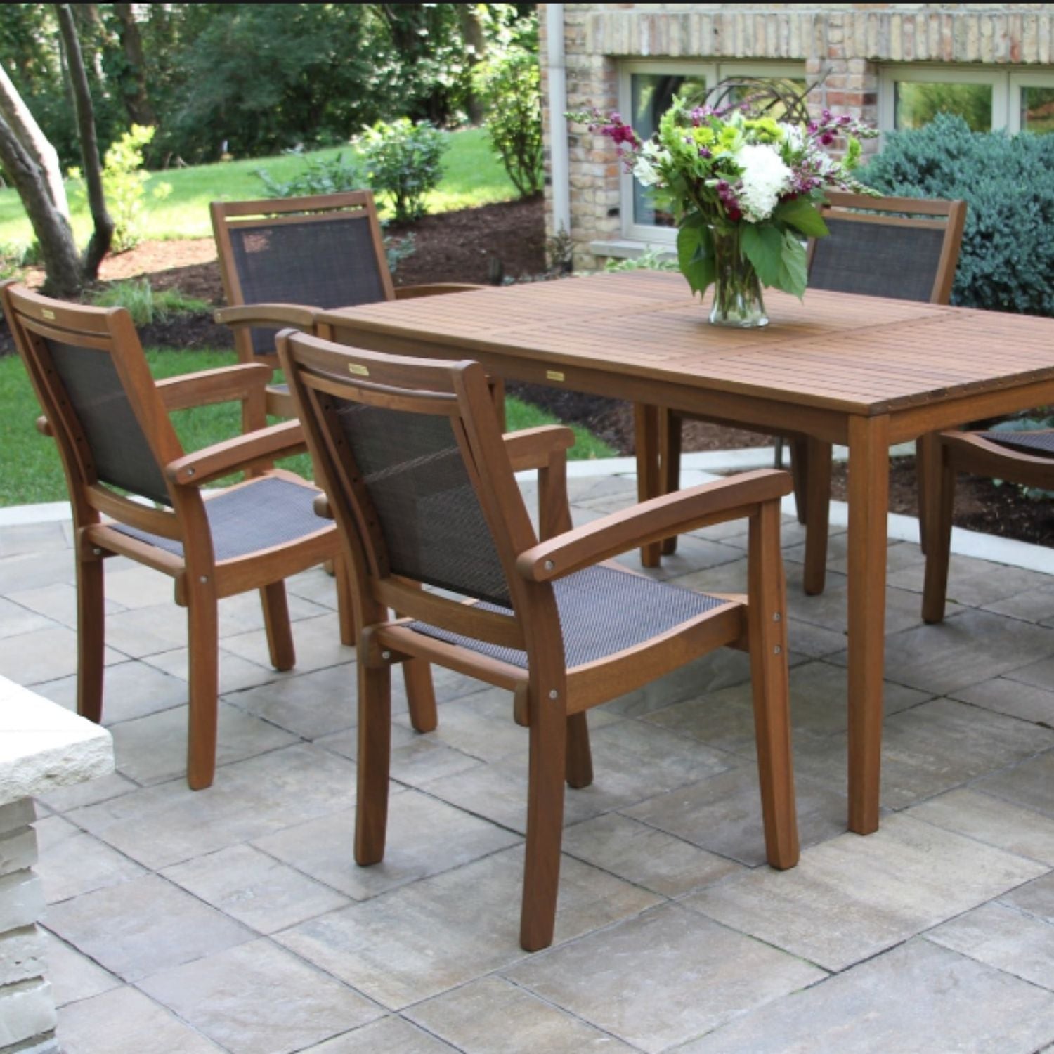 Eucalyptus wood 64" x 38" rectangular table and six stackable sling dining chairs.